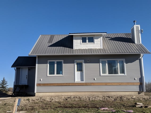 old-house-with-new-vinyl-siding-cladded-woodgrain-window-trims-and-white-vinyl-shake-in-gables